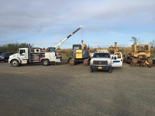 Precision Machinery mechanics fixing excavators in the parking lot