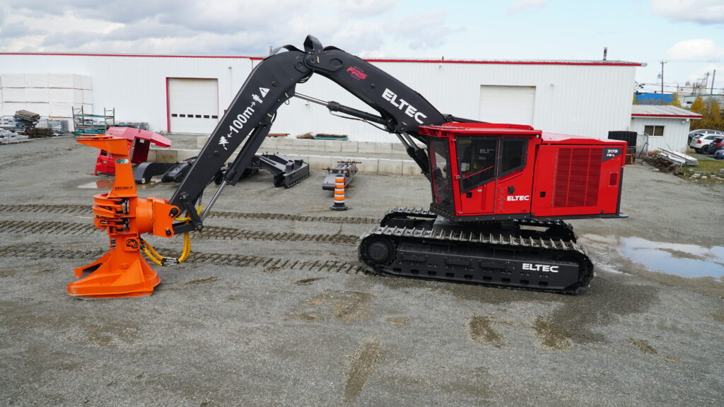Eltec 317B Feller Buncher with a harvesting head attached sitting in a parking lot.