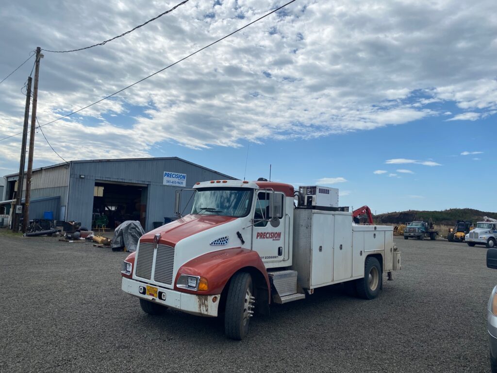 Precision Machinery service truck sitting in front of the Precision Machinery shop.
