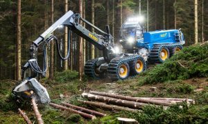 Blue Rottne log loader in a forest