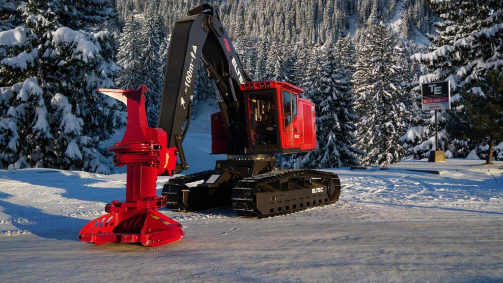 Eltec 317B with a Quadco processing head sitting in a snowy woods