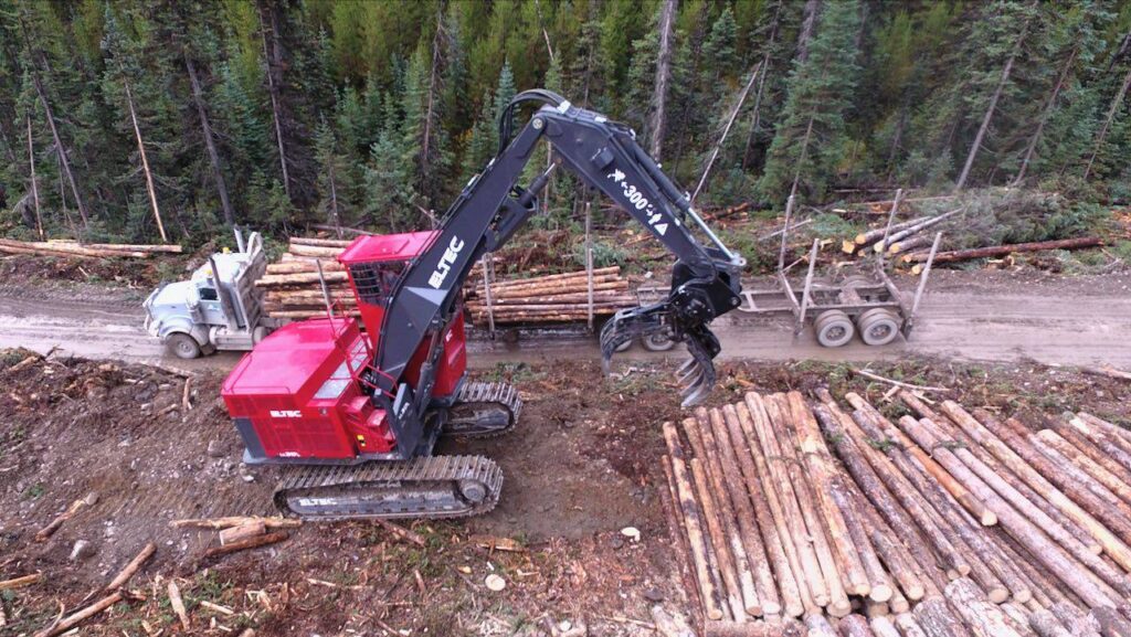 Eltec 317B log loader moving logs on a landing