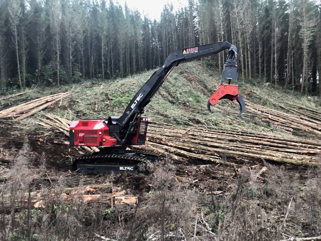 Eltec FH317 feller harvester with grapples sitting at a log site