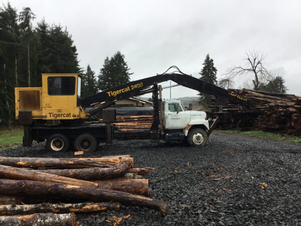 Tigercat 240B attached to an International semi truck