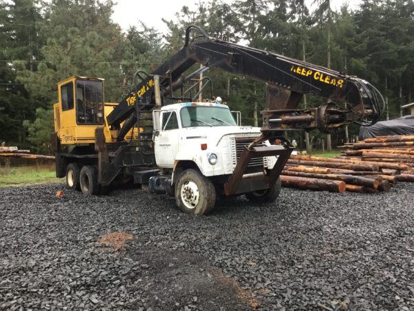 Tigercat 240B attached to an International semi truck