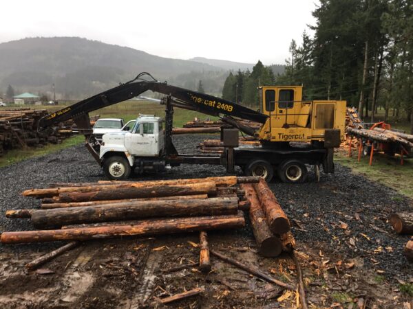 Tigercat 240B attached to an International semi truck